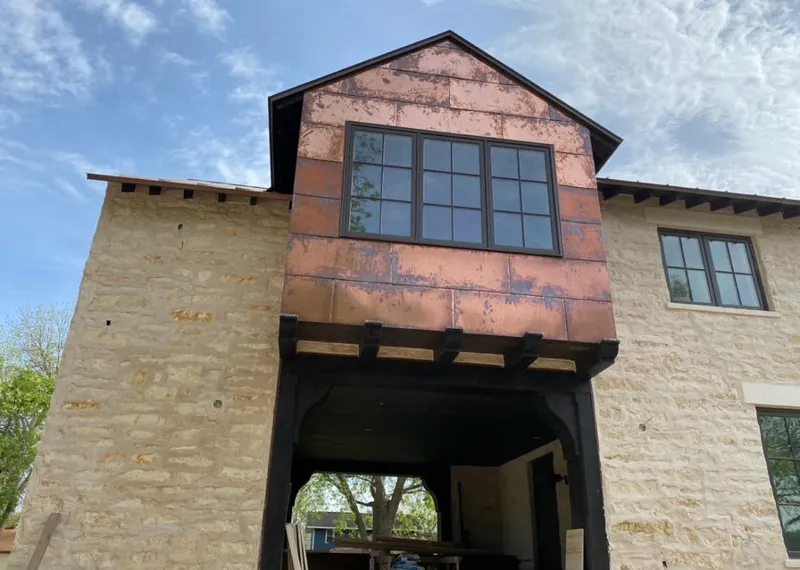 Copper metal panel facade on a stone building for Roof Repair in Pelham